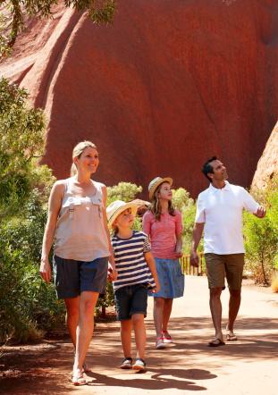 Family with 2 young children on base walk of Ayers Rock Uluru