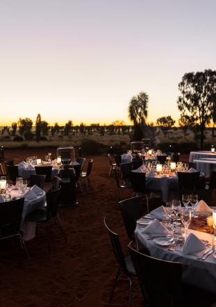 Dining tables set up outdoors at dusk